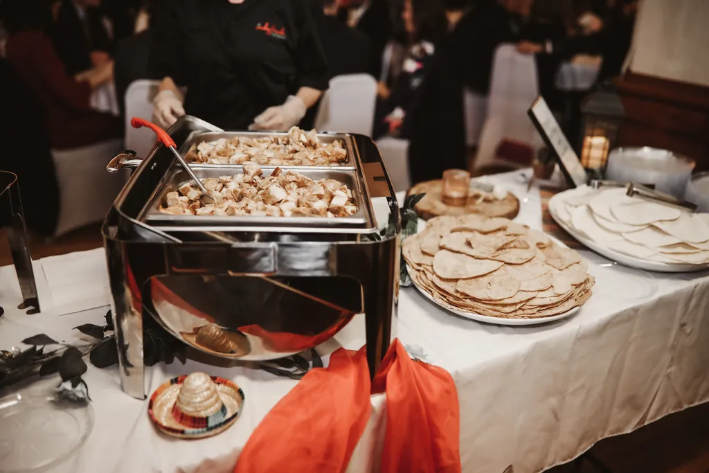Chafing dishes and platters on a buffet table set up by an outside caterer at McGowan Hall