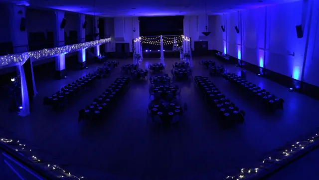The empty Grand Hall lit deep blue before guests arrive