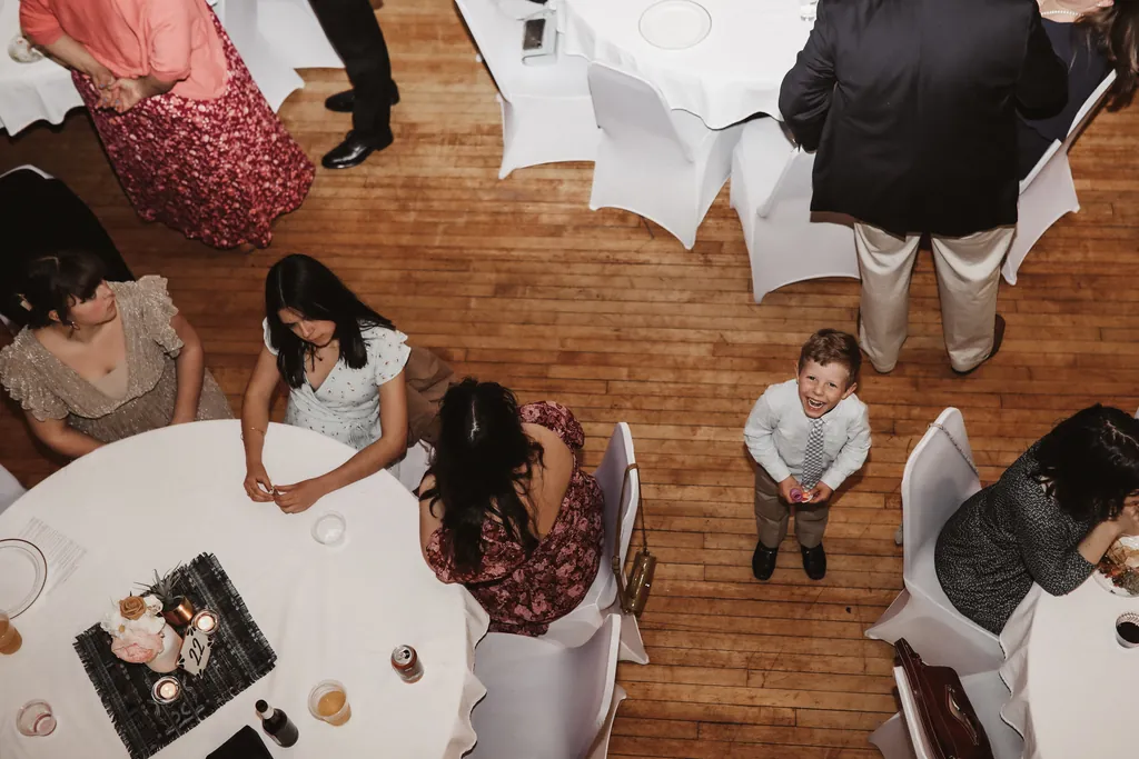 Overhead view of guests seated around a round table on the maple floor