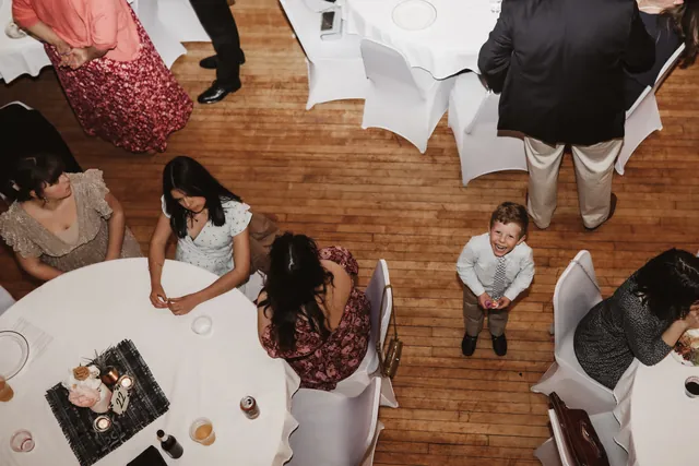 Overhead view of guests around a round table on the maple floor