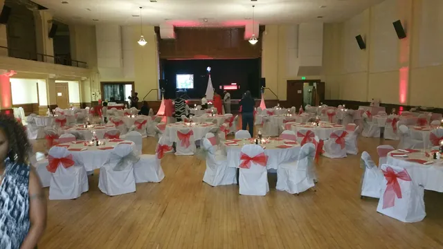 The Grand Hall set with pink chair sashes and round tables for a quinceañera