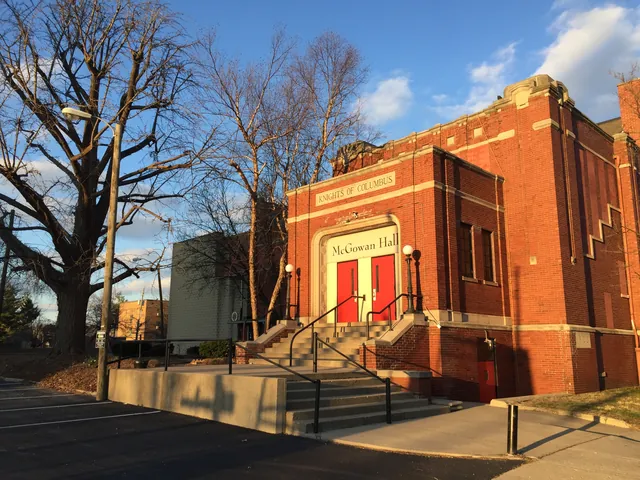 The brick exterior of McGowan Hall against a blue sky